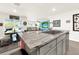 Kitchen with granite island, stainless steel appliances, and view of living room at 7729 Rosewood Garden Loop, Tampa, FL 33637