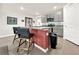 Modern kitchen with gray cabinets, granite countertops, and breakfast bar at 7729 Rosewood Garden Loop, Tampa, FL 33637
