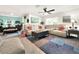 Spacious living room featuring a large sectional sofa and coffee table at 7729 Rosewood Garden Loop, Tampa, FL 33637