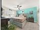 Main bedroom with ceiling fan, large bed, and ensuite bathroom at 7729 Rosewood Garden Loop, Tampa, FL 33637
