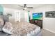 Main bedroom with king-size bed and flat-screen TV at 7729 Rosewood Garden Loop, Tampa, FL 33637