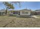 Large backyard with a screened patio and fenced boundaries at 7311 Buchanan Dr, Port Richey, FL 34668
