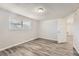 Well-lit bedroom with wood-look floors and a large window at 7311 Buchanan Dr, Port Richey, FL 34668