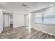 Bright living room featuring wood-look floors and neutral walls at 7311 Buchanan Dr, Port Richey, FL 34668