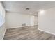 Bright living room featuring light gray walls and wood-look flooring at 7311 Buchanan Dr, Port Richey, FL 34668