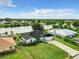 Aerial view of canal-front home with large backyard and detached garage at 7384 Van Lake Dr, Englewood, FL 34224
