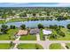 Aerial view of a waterfront property with canal access and neighboring homes at 7384 Van Lake Dr, Englewood, FL 34224