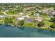 Aerial view of waterfront home with canal access and lush landscaping at 7384 Van Lake Dr, Englewood, FL 34224
