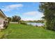 Large grassy backyard with canal view and privacy fence at 7384 Van Lake Dr, Englewood, FL 34224
