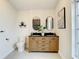 Bathroom with a double vanity and stylish wood cabinets at 7384 Van Lake Dr, Englewood, FL 34224