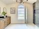 Modern bathroom with a double vanity, large shower, and elegant fixtures at 7384 Van Lake Dr, Englewood, FL 34224