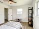 Bedroom with a full bed, ceiling fan and wood flooring at 7384 Van Lake Dr, Englewood, FL 34224