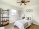Cozy bedroom with wood floors, ceiling fan, and stylish decor at 7384 Van Lake Dr, Englewood, FL 34224