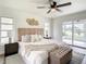 Primary bedroom with a king-size bed and sliding doors to patio at 7384 Van Lake Dr, Englewood, FL 34224