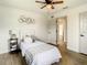 Small bedroom with twin bed, ceiling fan and wood flooring at 7384 Van Lake Dr, Englewood, FL 34224