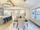 Bright dining room features a large table, chandelier, and hardwood floors at 7384 Van Lake Dr, Englewood, FL 34224