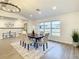 Bright dining room with hardwood floors, chandelier, and large window at 7384 Van Lake Dr, Englewood, FL 34224