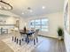 Modern farmhouse dining room with a large window and hardwood floors at 7384 Van Lake Dr, Englewood, FL 34224