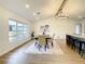 Open concept dining area with hardwood floors and a chandelier at 7384 Van Lake Dr, Englewood, FL 34224