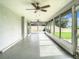 Bright enclosed patio with multiple ceiling fans at 7384 Van Lake Dr, Englewood, FL 34224