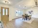 Light and airy entryway with wood-look flooring and a stylish door at 7384 Van Lake Dr, Englewood, FL 34224