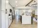 Modern kitchen with gray cabinets, stainless steel appliances, and large island at 7384 Van Lake Dr, Englewood, FL 34224