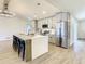 Modern kitchen with gray cabinets, large island, and stainless steel appliances at 7384 Van Lake Dr, Englewood, FL 34224