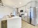 Modern kitchen with gray cabinets, quartz countertops, and stainless steel appliances at 7384 Van Lake Dr, Englewood, FL 34224