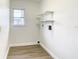 Bright laundry room with shelving and vinyl flooring at 7384 Van Lake Dr, Englewood, FL 34224