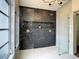 Walk-in shower with double shower heads and modern tile at 7384 Van Lake Dr, Englewood, FL 34224