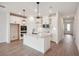 Modern kitchen featuring white cabinets, quartz countertops, and an island at 117 Runaway Field Ave, Nokomis, FL 34275