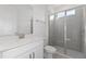 Clean bathroom with white vanity, walk-in shower, and gray tile at 1044 Signet Dr, Apollo Beach, FL 33572