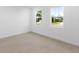 Bright bedroom with tile floors and two large windows at 1044 Signet Dr, Apollo Beach, FL 33572