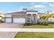 Beautiful single-Gathering home showcasing a manicured lawn and a three-car garage at 1044 Signet Dr, Apollo Beach, FL 33572