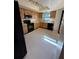 Kitchen features wood cabinets, black appliances, and tile floors at 2513 Lancaster Dr, Sun City Center, FL 33573