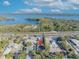 Aerial view showing home's location near water, highway, and other properties at 990 Sunrise Dr, Tarpon Springs, FL 34689