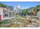 Large backyard with screened porch and a small patio table at 990 Sunrise Dr, Tarpon Springs, FL 34689