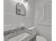 Clean bathroom with granite countertop, white tile, and a window at 990 Sunrise Dr, Tarpon Springs, FL 34689