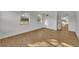 Spacious bedroom with wood flooring and view into the kitchen at 990 Sunrise Dr, Tarpon Springs, FL 34689