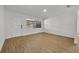 Bright bedroom with white door and large window, showcasing wood floors at 990 Sunrise Dr, Tarpon Springs, FL 34689