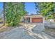 House exterior showcasing carport and orange garage door at 990 Sunrise Dr, Tarpon Springs, FL 34689