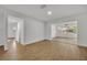 Spacious living area with wood-look floors and access to other rooms at 990 Sunrise Dr, Tarpon Springs, FL 34689