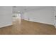 Open living area with wood-look floors and access to other rooms at 990 Sunrise Dr, Tarpon Springs, FL 34689