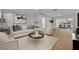 Living room features light beige couch, wood floors, and view to dining area at 990 Sunrise Dr, Tarpon Springs, FL 34689