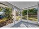 Cozy screened porch overlooking a private backyard at 990 Sunrise Dr, Tarpon Springs, FL 34689