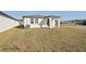 New home with grassy backyard and AC unit at 120 Whiteland Bnd, Nokomis, FL 34275