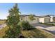 House exterior showcasing a landscaped yard and driveway at 120 Whiteland Bnd, Nokomis, FL 34275