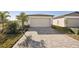New home with attached garage and brick driveway at 120 Whiteland Bnd, Nokomis, FL 34275