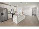 Modern kitchen with island, stainless steel appliances, and granite countertops at 120 Whiteland Bnd, Nokomis, FL 34275