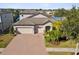 Two-story house with three car garage, and brick driveway at 1831 Cameron Ct, New Port Richey, FL 34655